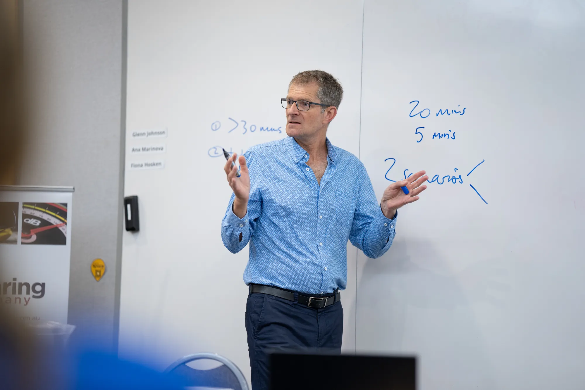 Director Glenn Johnson teaching a course in front of a whiteboard.