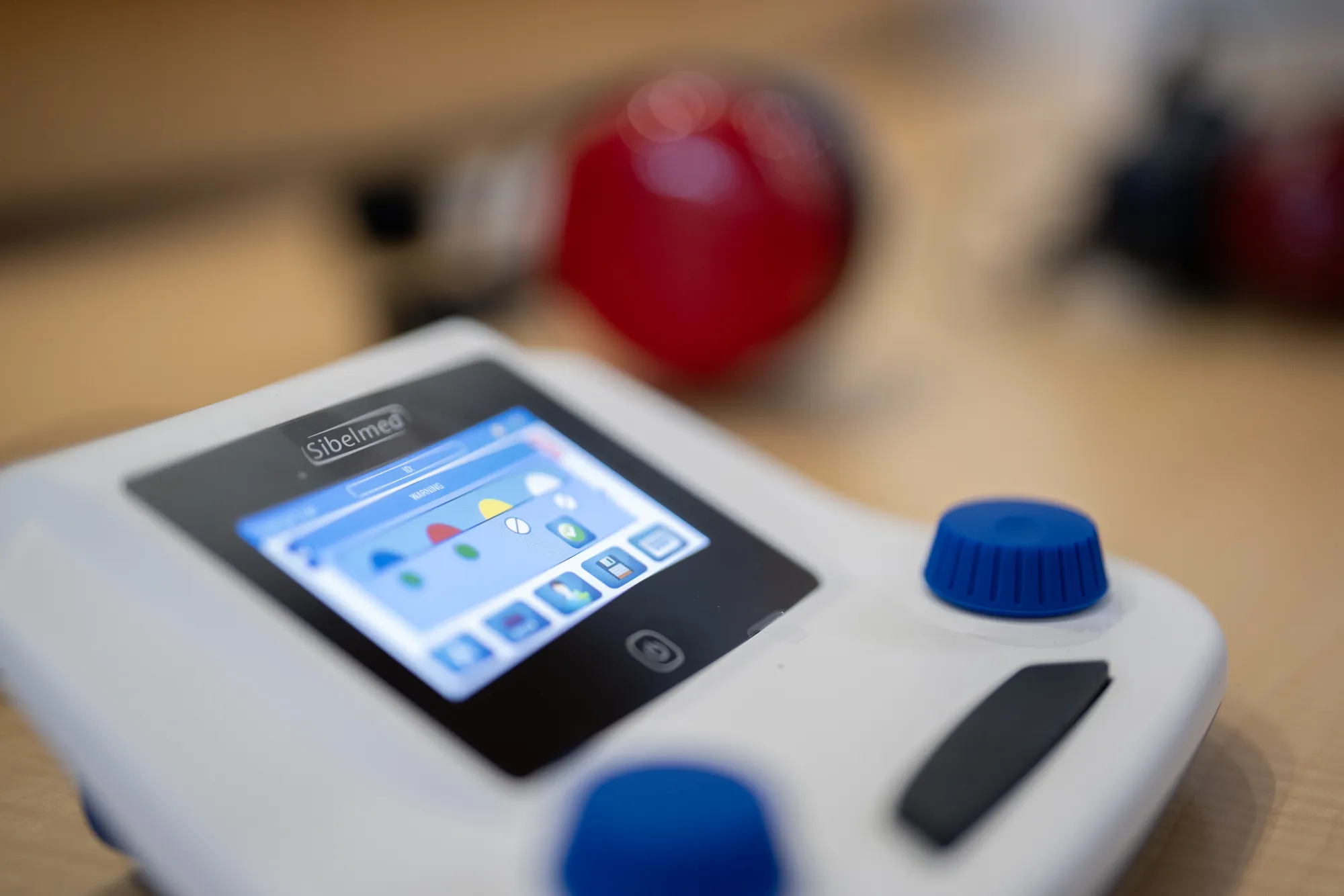 An audiometer with two blue knobs and a screen.