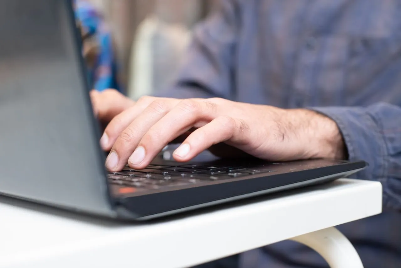 Someone typing on a laptop