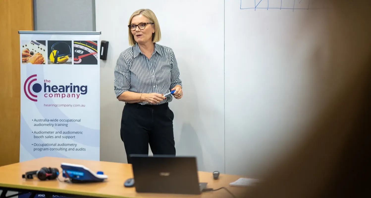 Fiona teaching a class in front of a whiteboard.