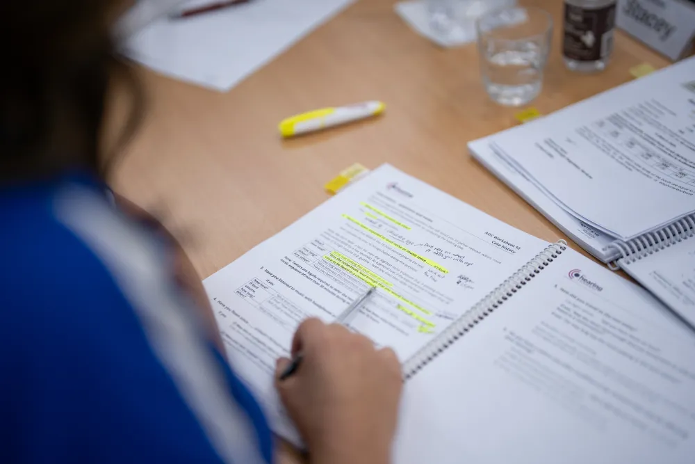 Participant reading a Hearing Company handout