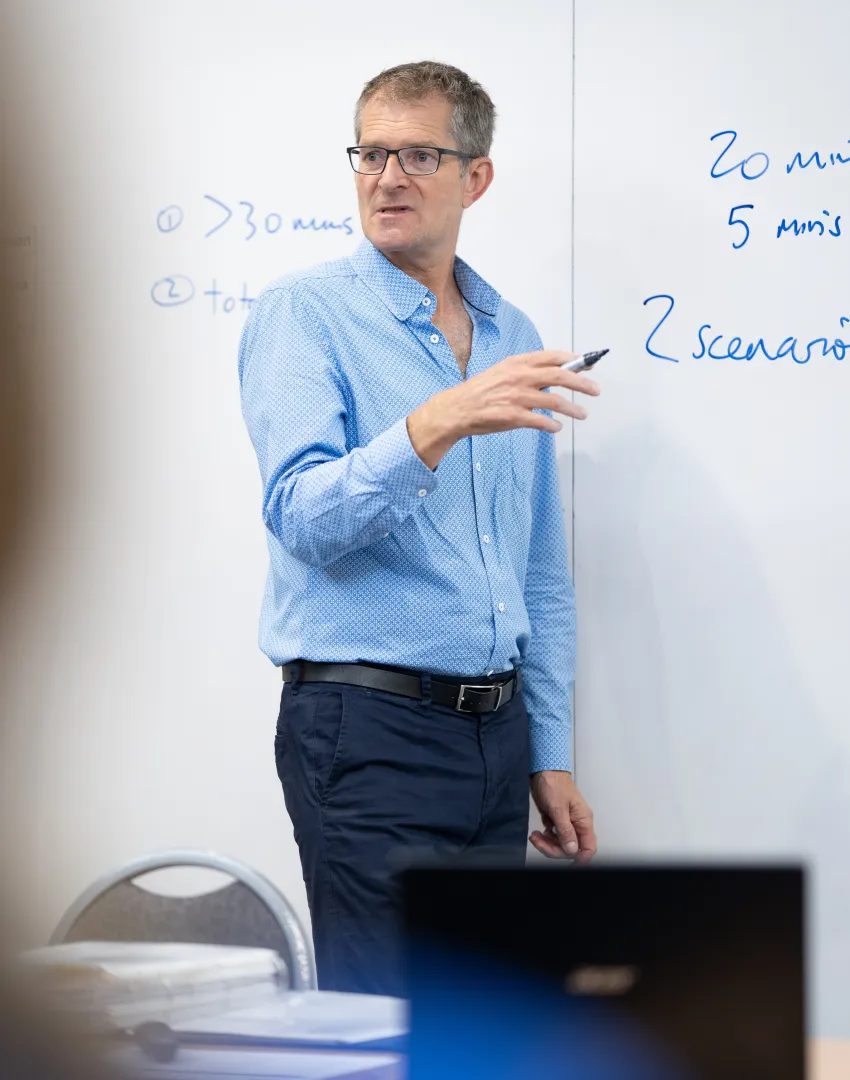 Glenn Johnson teaching in front of a classroom