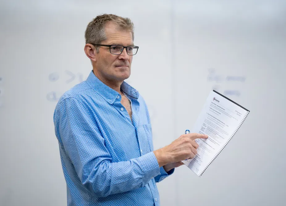 Glenn Johnson pointing at notes in front of whiteboard